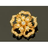 A floral style gold metal brooch,