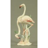 A Hutschenreuther porcelain figure group of flamingos, 20th century, standing amongst reeds,