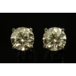 A pair of 18 ct white gold mounted diamond earrings, stones +/- 2.02 carats and + /- 2.