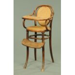 A Victorian child's bentwood highchair, with bergere back and seat. Height to top rail 92 cm.