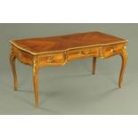 A French bureau plat with gilt metal mounts, early 20th century, having a quarter veneered top,
