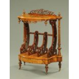 A Victorian walnut whatnot stand, with fretwork pediment, shaped outline, three divisions,