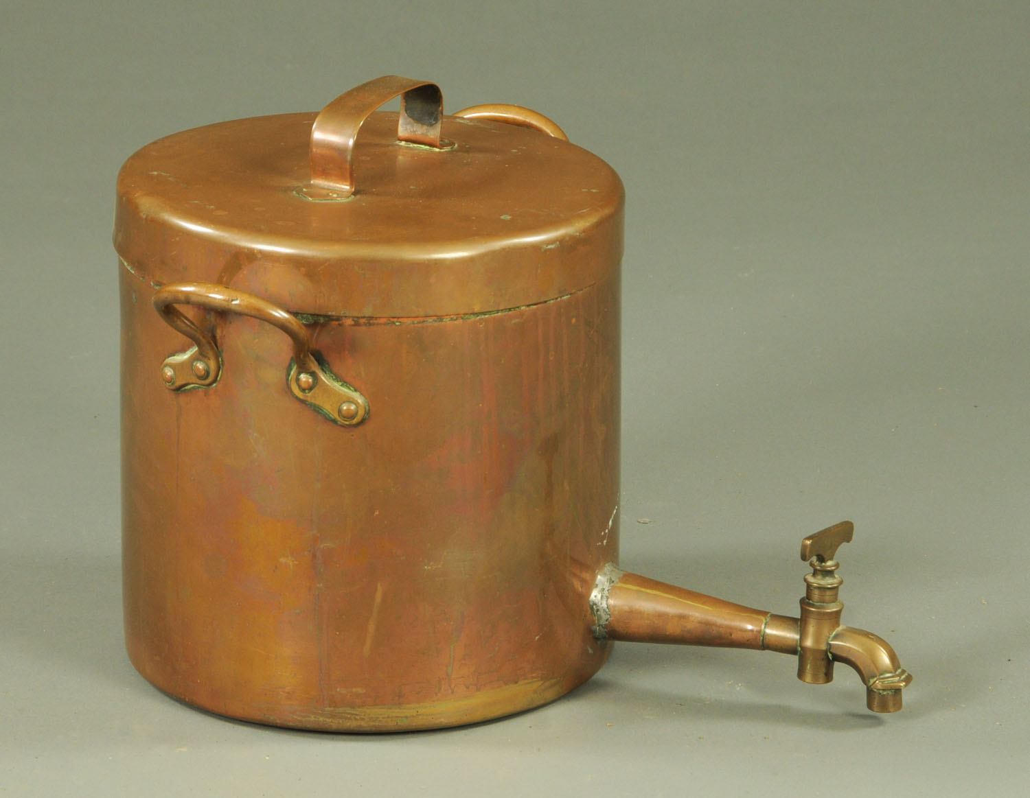 A large copper 19th century hot water kettle, with two carrying handles and tap. Height 30 cm.