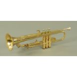 A Corton brass trumpet, the keys inset with mother of pearl, in fitted case.