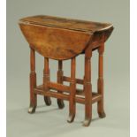 An antique oak small gate legged occasional table, with turned supports and single end drawer,