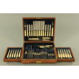 An Edwardian oak canteen of silver plated cutlery,