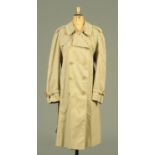 A ladies Aquascutum full length beige coat, with checked lining, size Reg. 42.