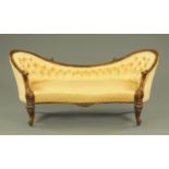 A Victorian boudoir settee, with carved walnut showframe,