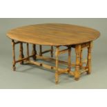 An oak double gate legged dining table. 176 cm x 174 cm open.