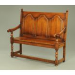 A dark oak settle, early 20th century,