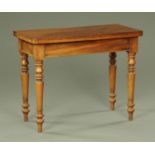 A Victorian mahogany turnover top tea table, raised on turned tapered legs. Width 95 cm.