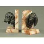 A pair of French bookends, spelter dog masks, spaniel and companion, one stamped "Lecourtier".