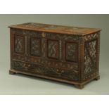 A late 17th century oak coffer, dated 1695, later carved,