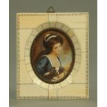 An early 20th century portrait miniature of a lady with a lapdog, all within a piano ivory frame.