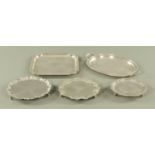 Five silver plated salvers/trays. Widest 41 cm.