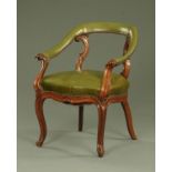 A Victorian mahogany library chair, upholstered in green leather,