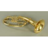 A brass baritone horn by Roy Benson, the horn with engraved name, +/- 74 cm long,