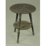 An Indian ebony carved occasional table,
