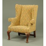 A Georgian style wing armchair,