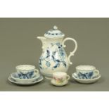 A Meissen onion pattern hot water jug and cover, two cups and saucers and side plate,