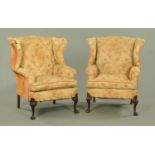 A pair of early 20th century wing armchairs,