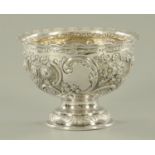 A Goldsmiths & Silversmiths Co. silver bowl, repousse with foliate scrollwork.