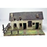 An interesting wooden and composition (British made) farmhouse built to a similar scale as