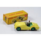 Dinky No. 105 Triumph TR2 Sports Car in pale yellow with green interior and figure. Generally E in F