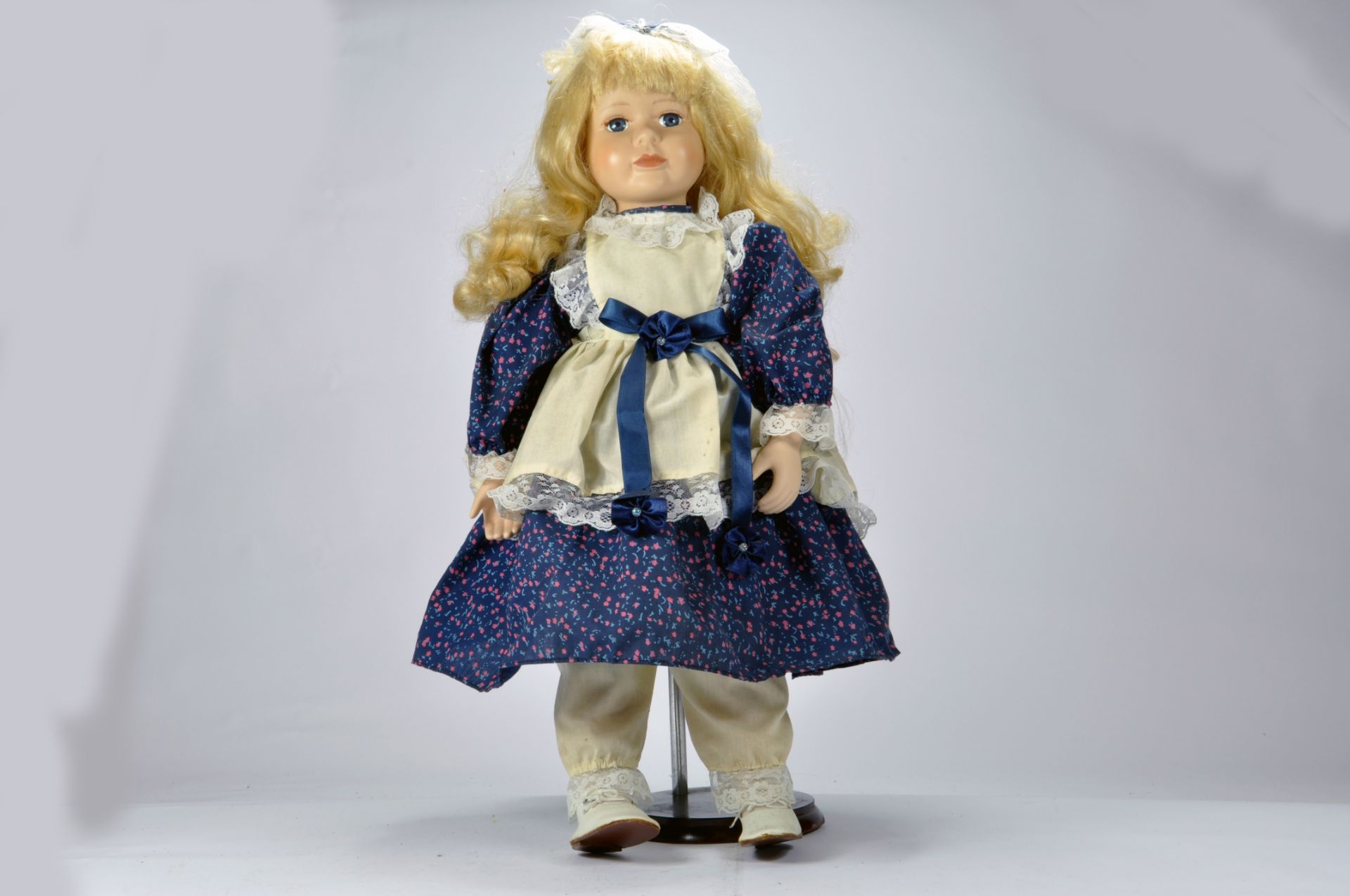 Large Porcelain Ceramic Doll complete with stand and box. E to NM.