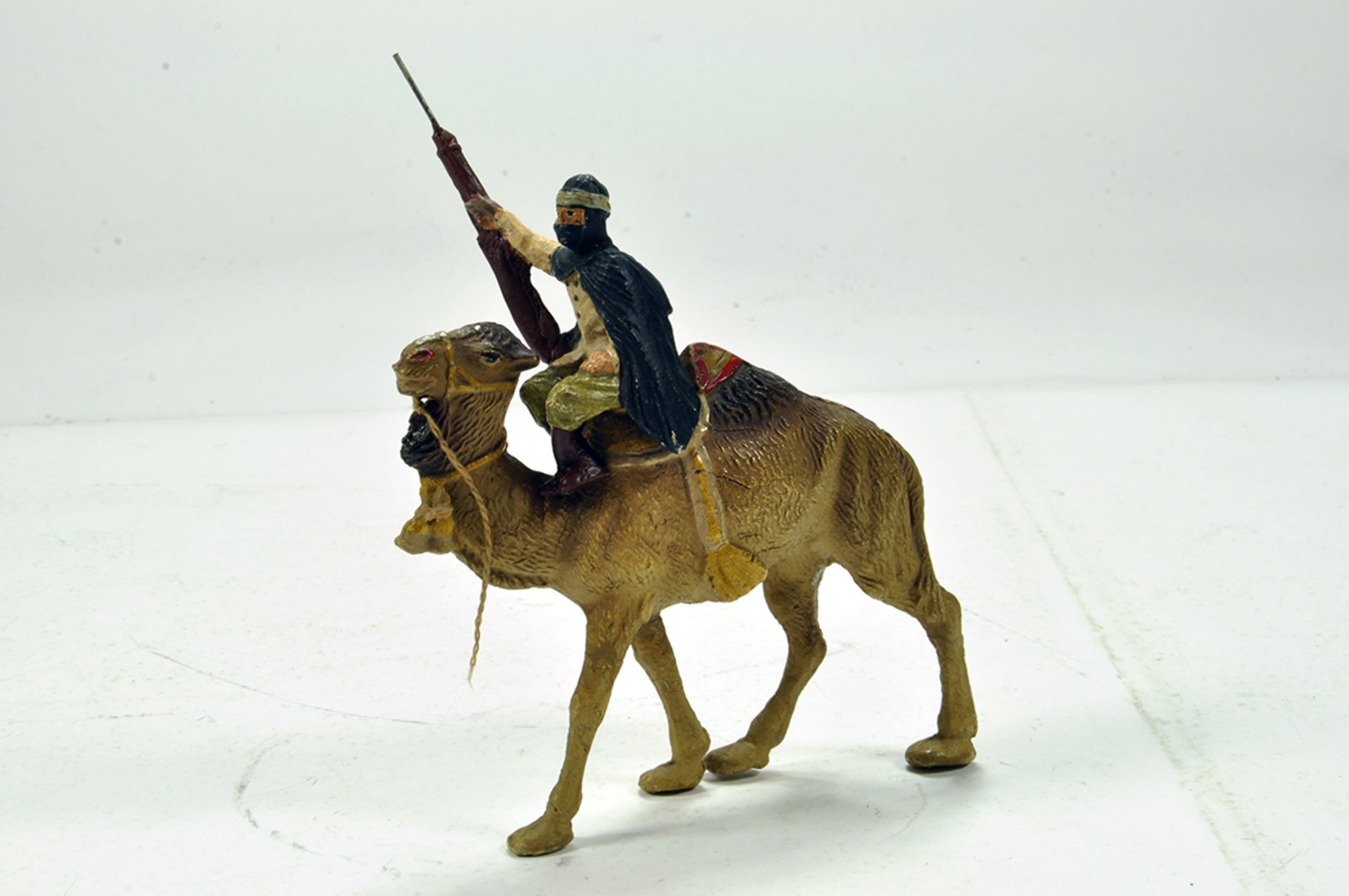 A scarce and finely presented INCAMIM compositional issue of a Bactrian Camel and Arab Rider.