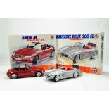 A duo of Burago issue Diecast Kit Built Vehicles. BMW M Roadster and Mercedes 200SL. Generally VG to