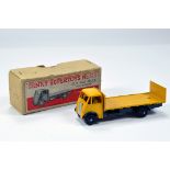 Dinky No. 513 Guy Flat Truck with Tailboard with deep yellow cab, flatbed and dark blue chassis.