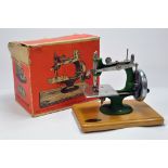A Grain Metal Made Toy Sewing Machine. This well preserved issue appears complete and comes with