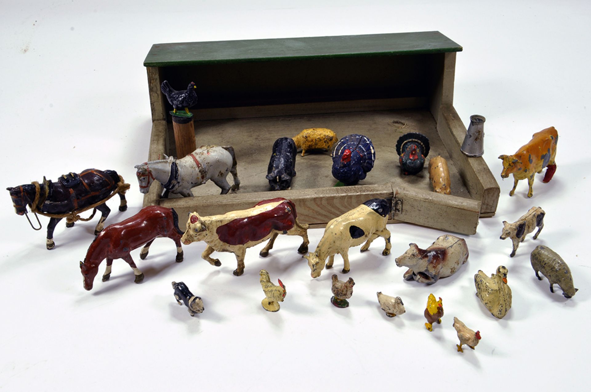 An interesting group of metal figures and wooden building including Farm Animals. Britains and