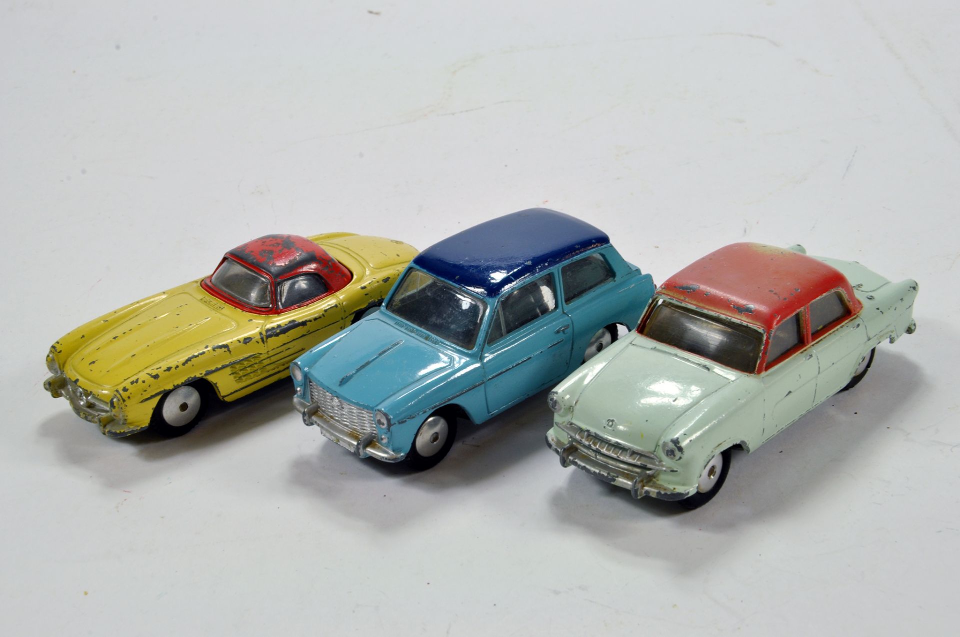 Corgi Trio of Diecast Car Issues comprising Austin A40, MB 300SL and Standard Vanguard. F to G. (3)