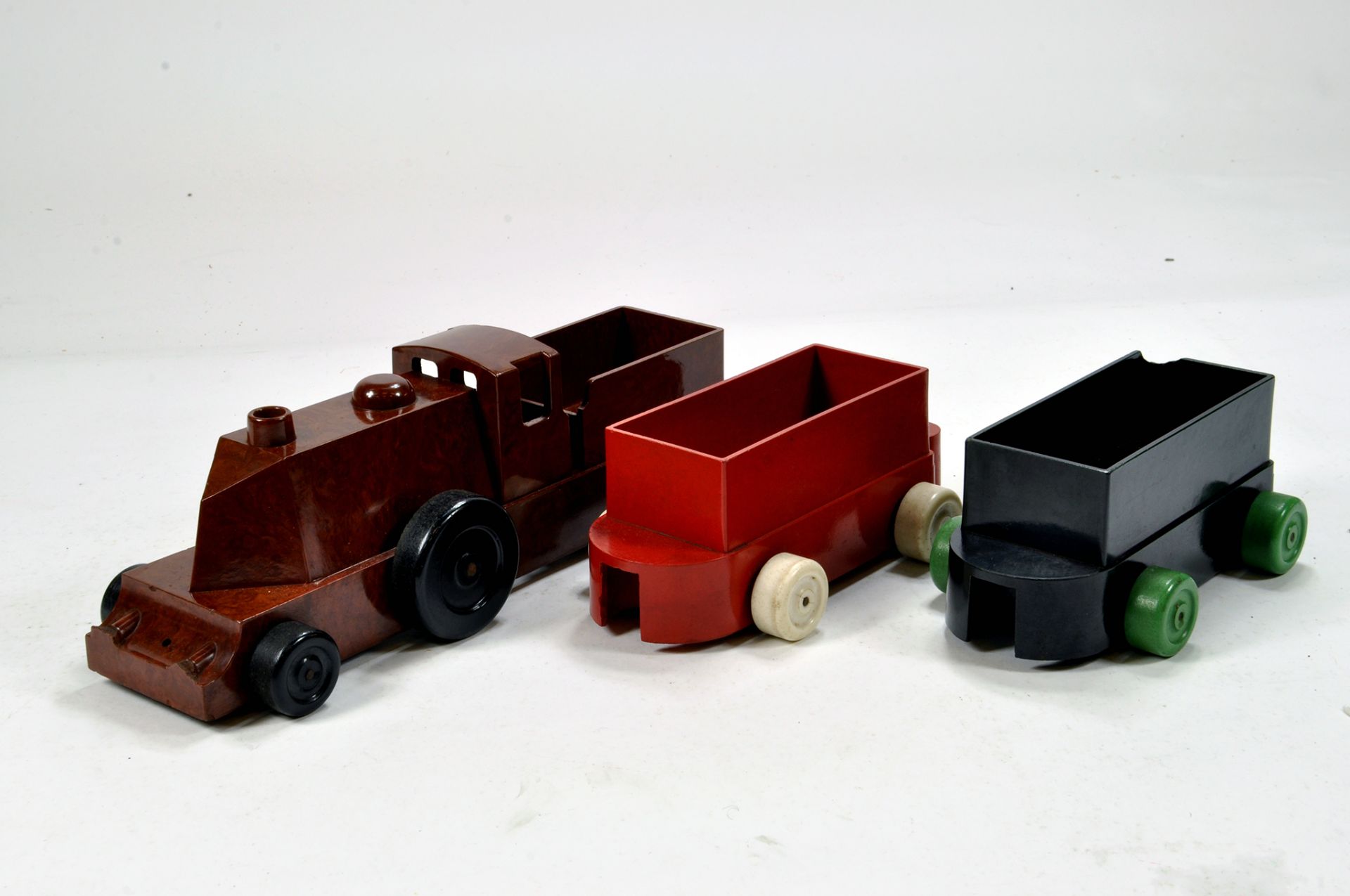 Hard to find Chad Valley Bakelite issue Railway Toys including Locomotive and Wagons. Generally VG