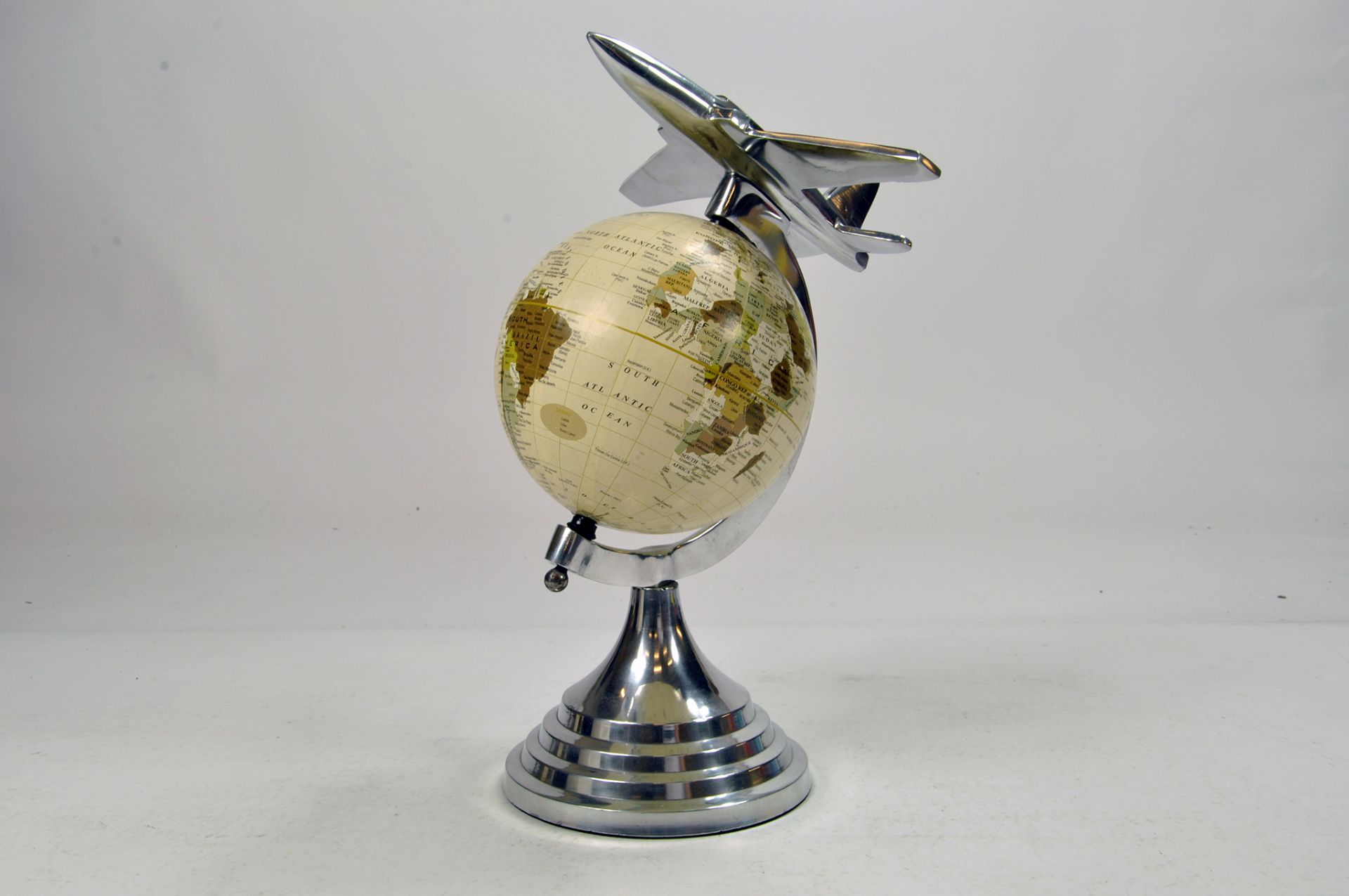 A scarce On Top of the World Globe featuring silver plate jet aircraft.