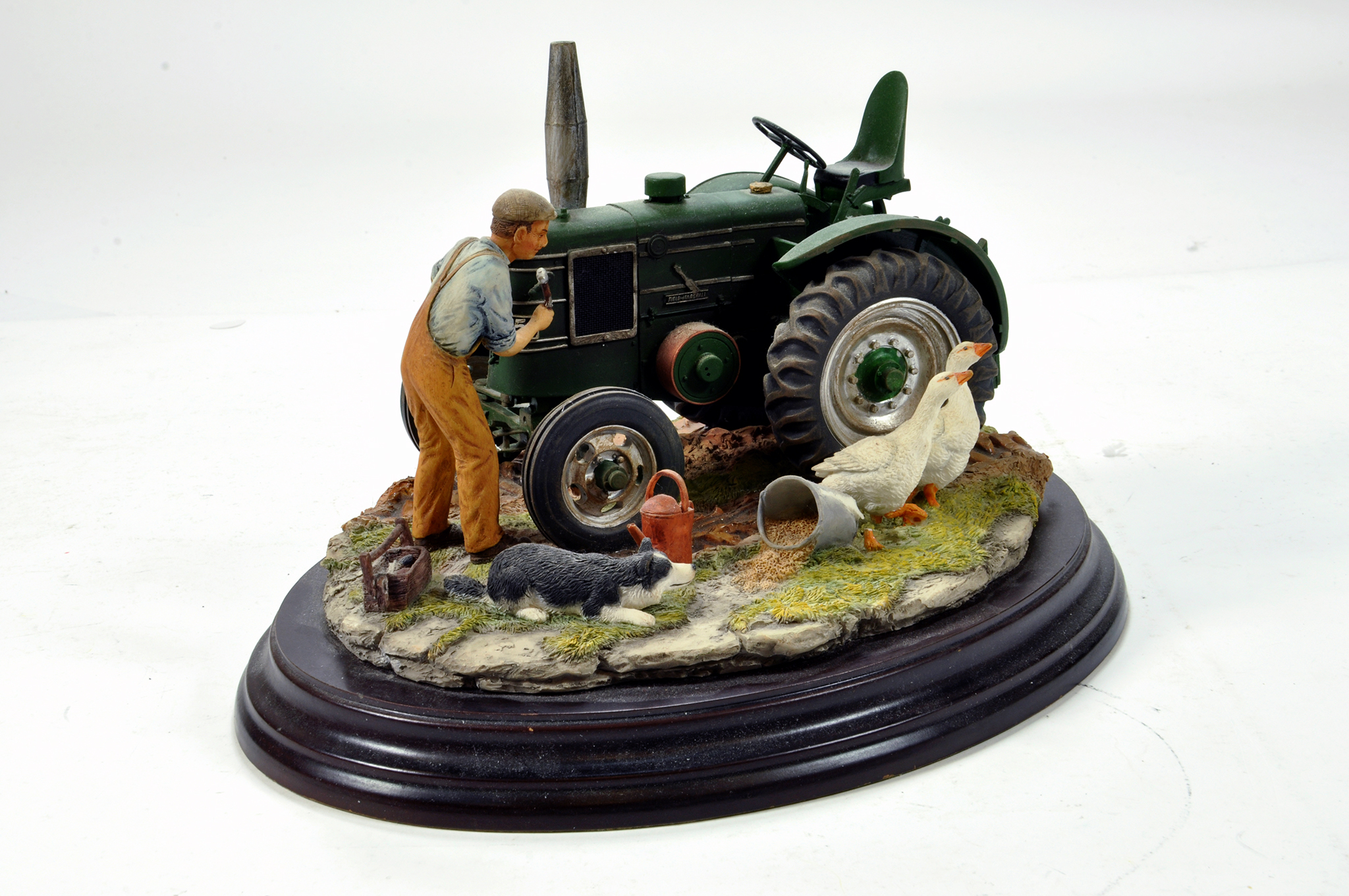 A static presentation piece comprising a Country Artists model featuring a Field Marshall Tractor.