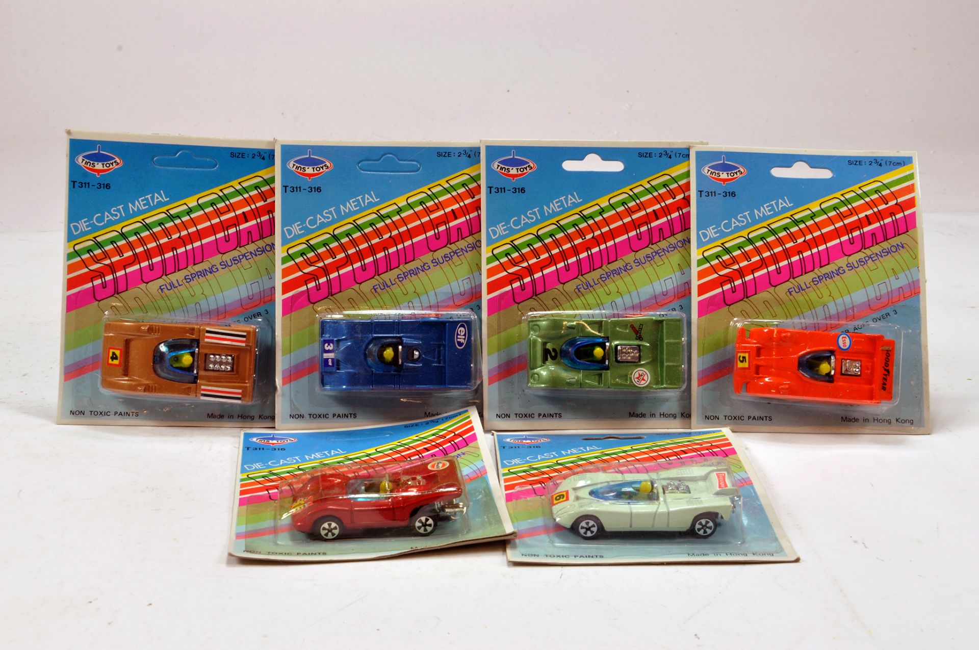 An assortment of carded diecast cars by Tins Toys. E to NM.