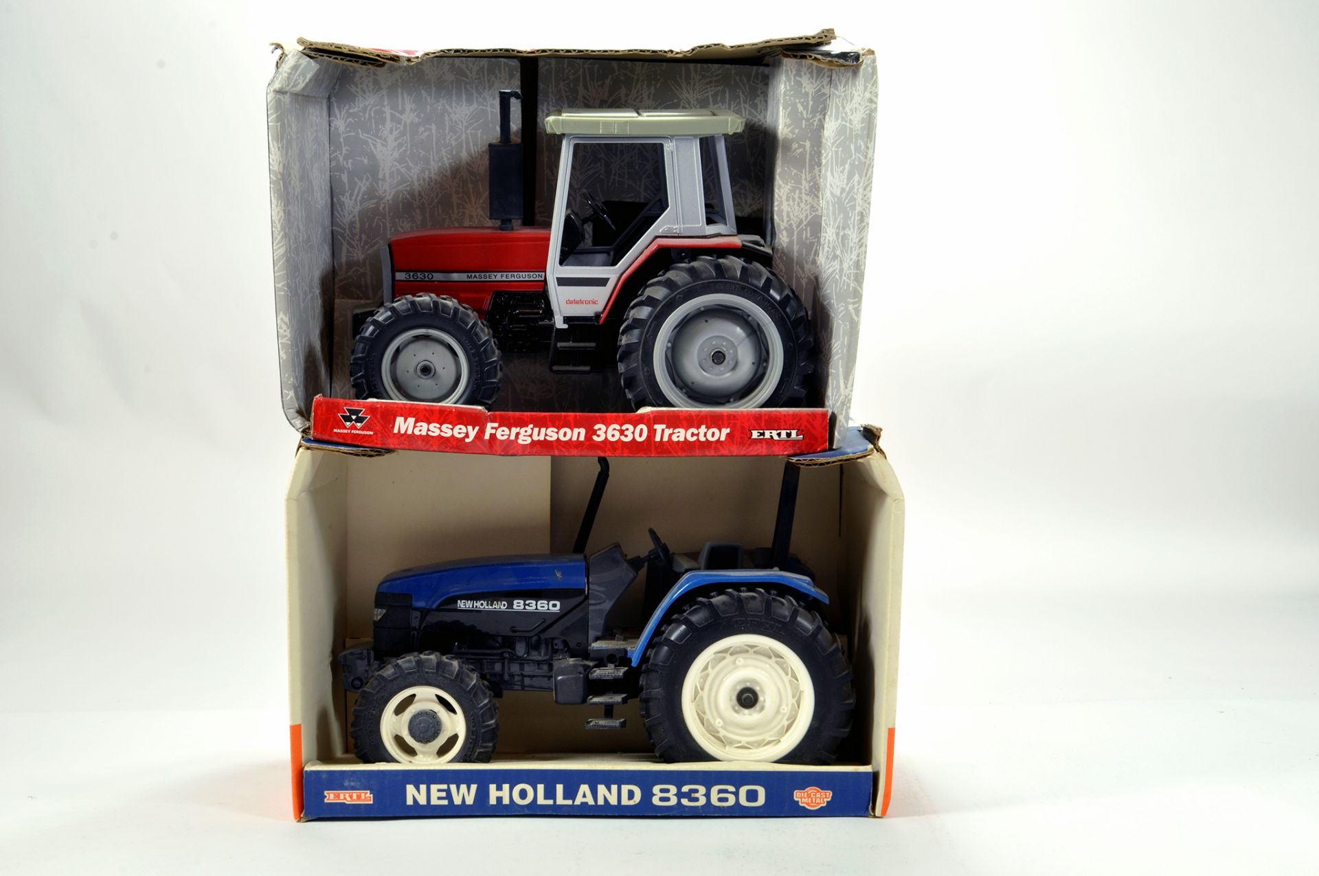 Ertl 1/16 Farm issues comprising Massey Ferguson and New Holland Tractors. Generally E to NM. (2)