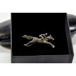 An interesting Sterling Silver and Marcasite Horse and Jockey Brooch with Ruby Eye, circa early