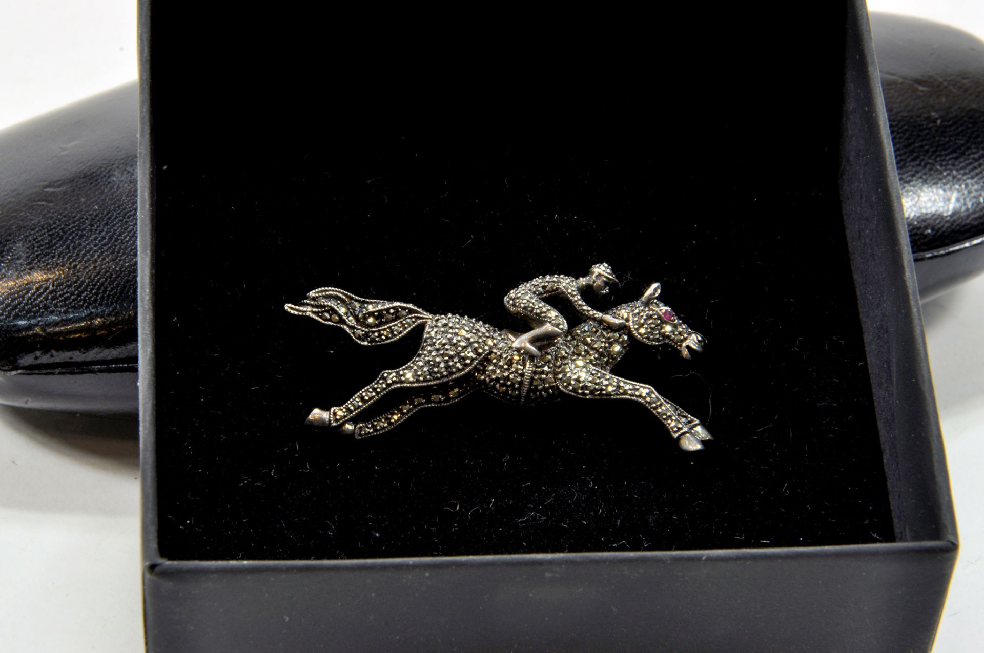 An interesting Sterling Silver and Marcasite Horse and Jockey Brooch with Ruby Eye, circa early