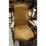 A Victorian rosewood framed rocking chair with carved scrollwork decoration to back and arms,