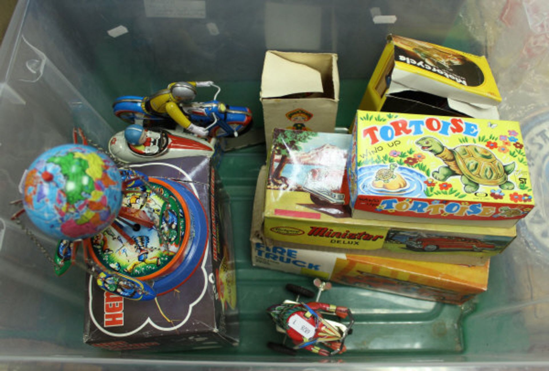 A collection of ten various tin plate clock work and traction toys including a Minister Delux car,