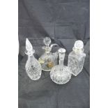 A selection of cut glass decanters and glass jugs to include a Kosta Elis Bergh faceted decanter of