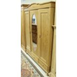 A pine triple wardrobe with three drawers