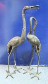 A pair of bronzed metal crane figures