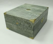 A green limed oak and brass bound trunk by Gustave Keller,