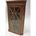 An Edwardian mahogany and satinwood strung hanging corner cabinet