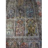 A Persian carpet, the central panel set with tiled pattern, each tile set with a floral design,